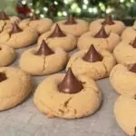 Bake the best homemade Peanut Butter Blossom Cookies with this easy recipe. Soft, chewy peanut butter cookies topped with Hershey’s Kisses – perfect for any occasion!