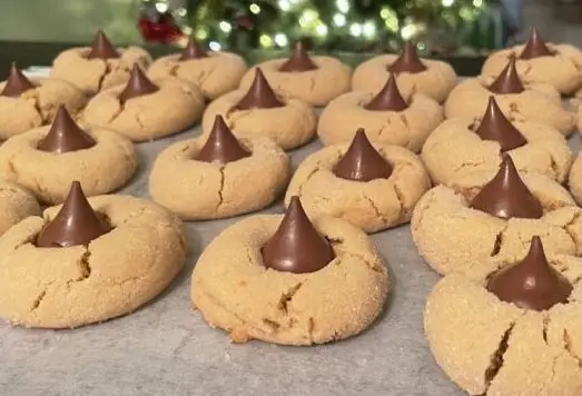 Bake the best homemade Peanut Butter Blossom Cookies with this easy recipe. Soft, chewy peanut butter cookies topped with Hershey’s Kisses – perfect for any occasion!